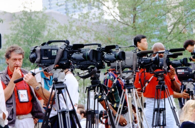 People and cameras lined up recording