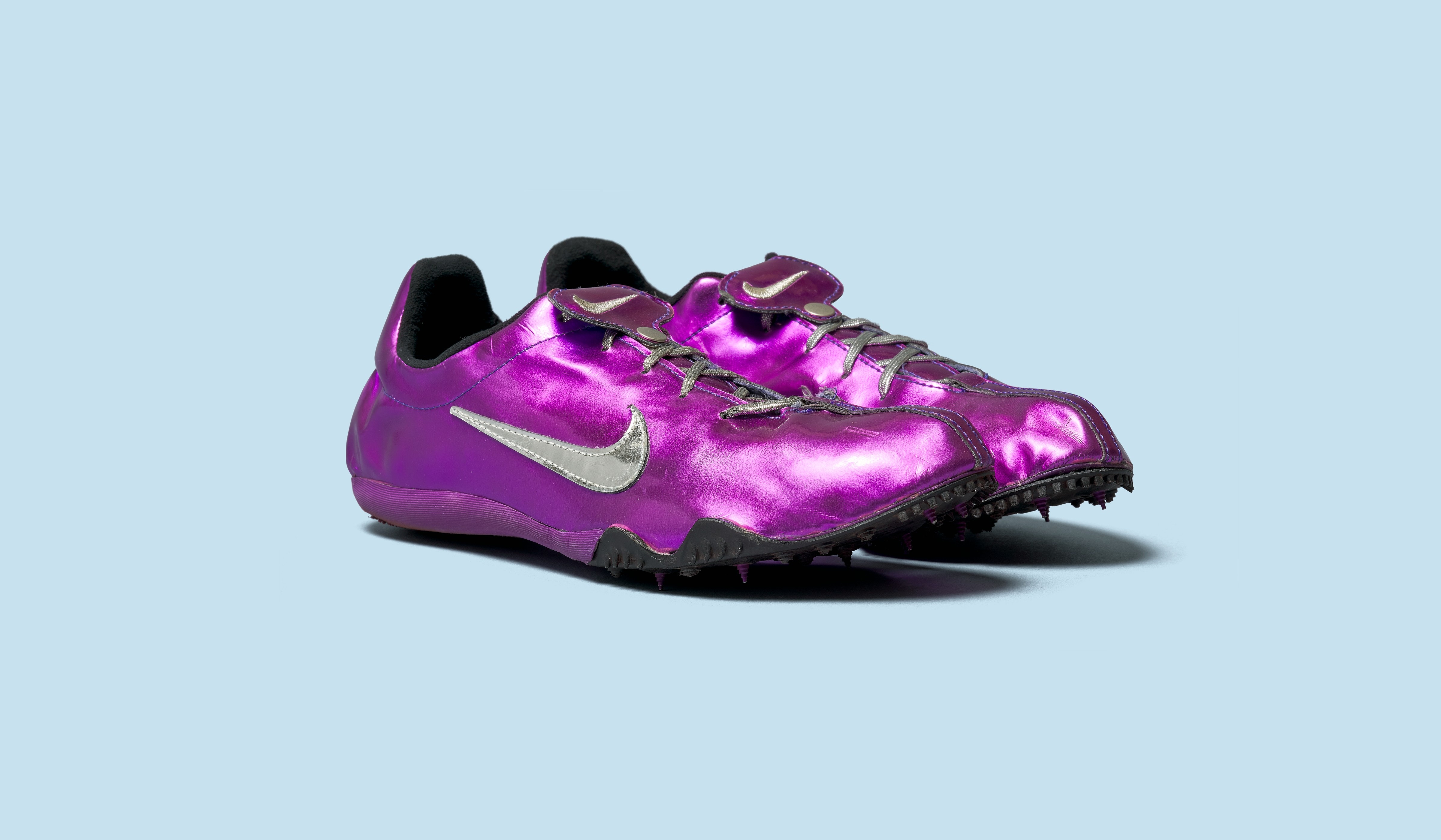 Purple track shoes on blue background