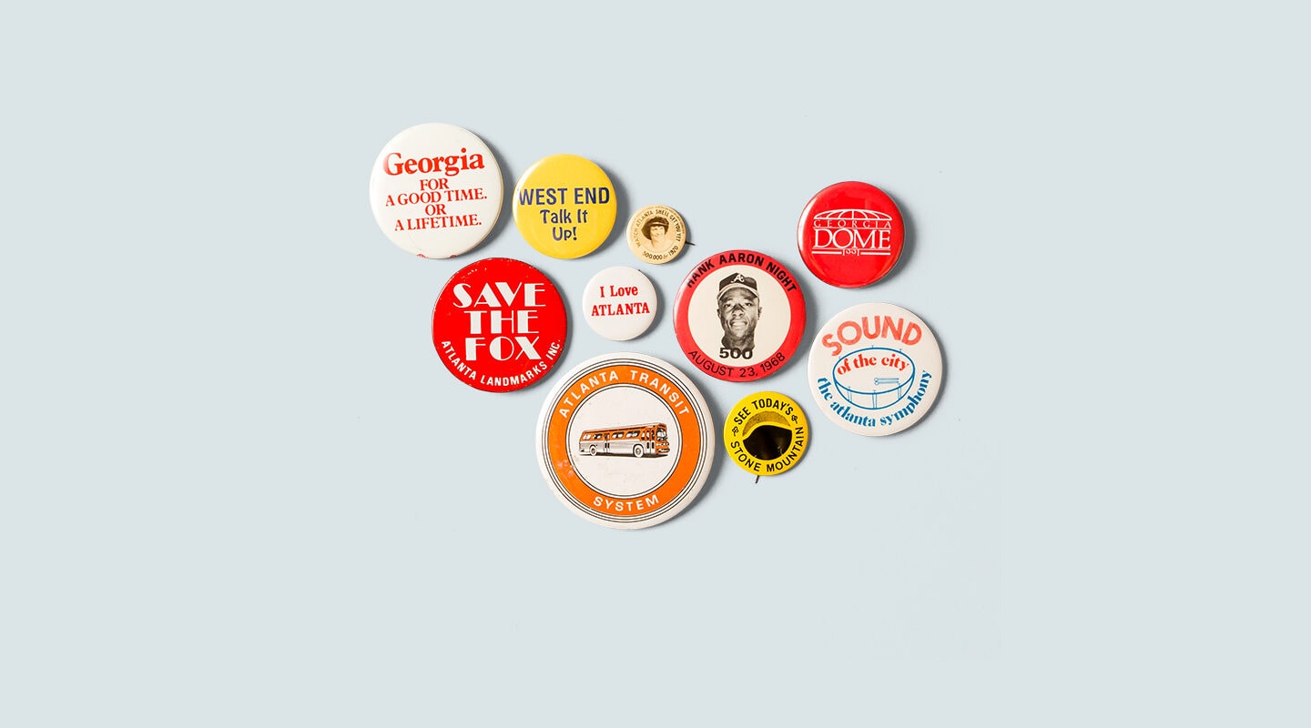 Multi-colored pin buttons with various text about Georgia on blue background