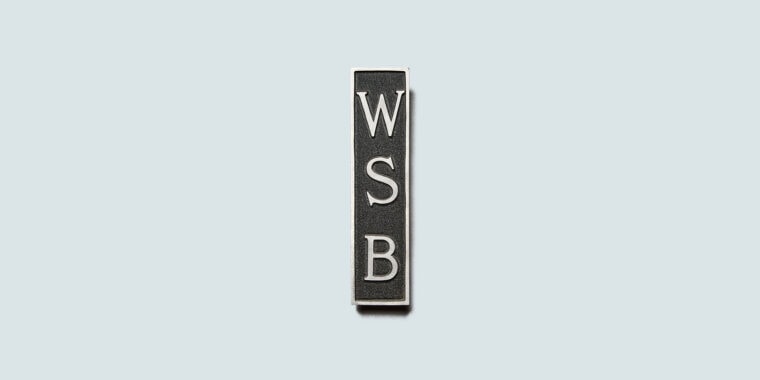 Black and silver sign with engraved WSB letters on blue background
