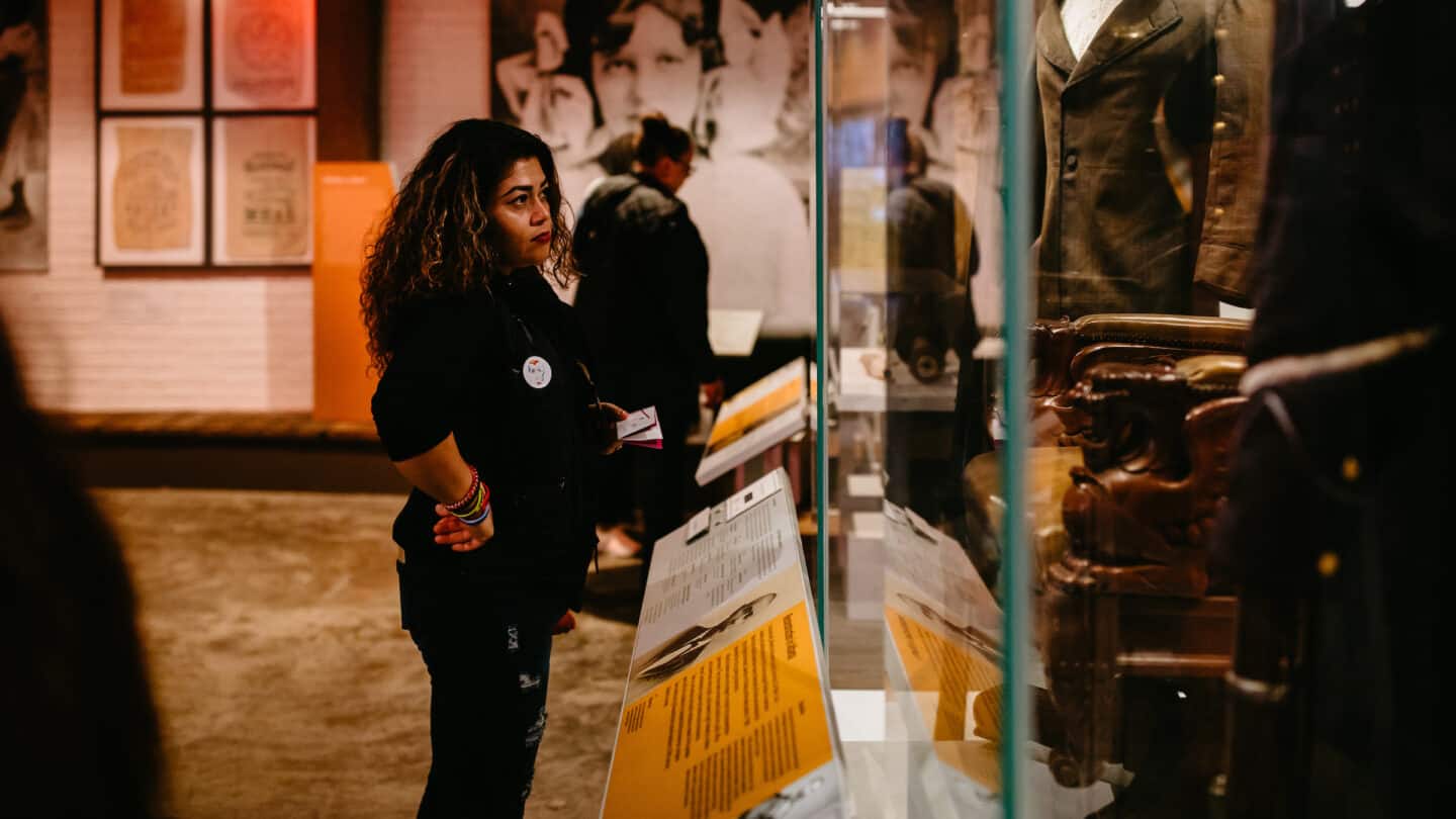 woman looking at exhibit Gatheround, stories of Atlanta