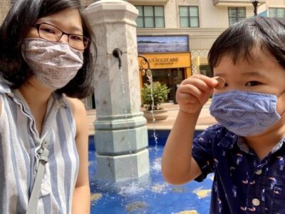 A woman and her son at a fountain