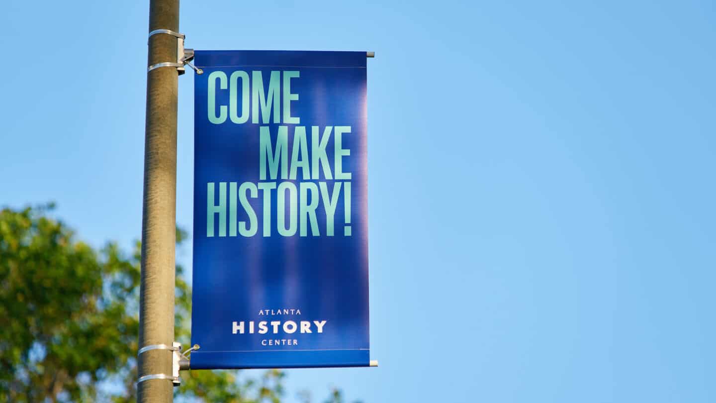 "Come Make History" blue sign at main entrance to Atlanta History center