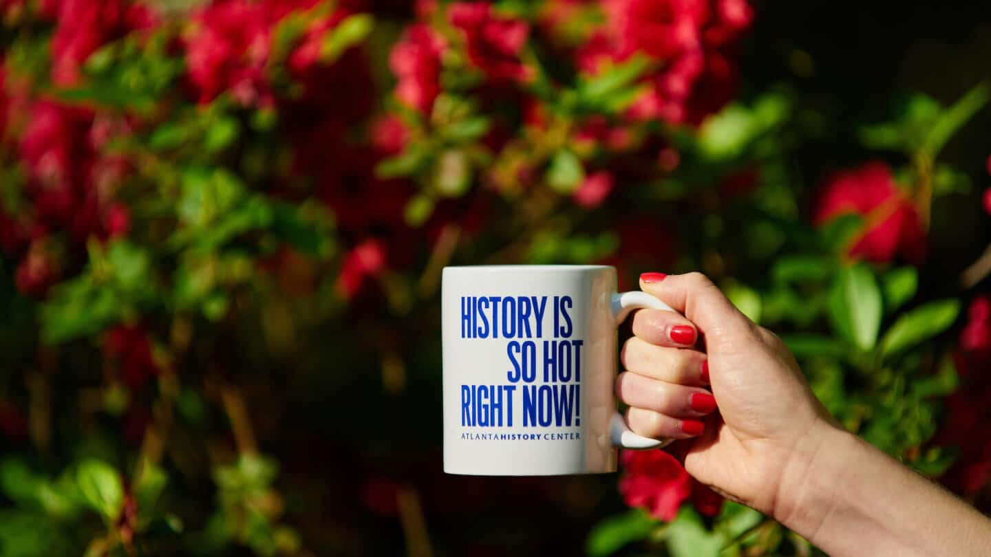 white cup with blue words about history from the museum shop