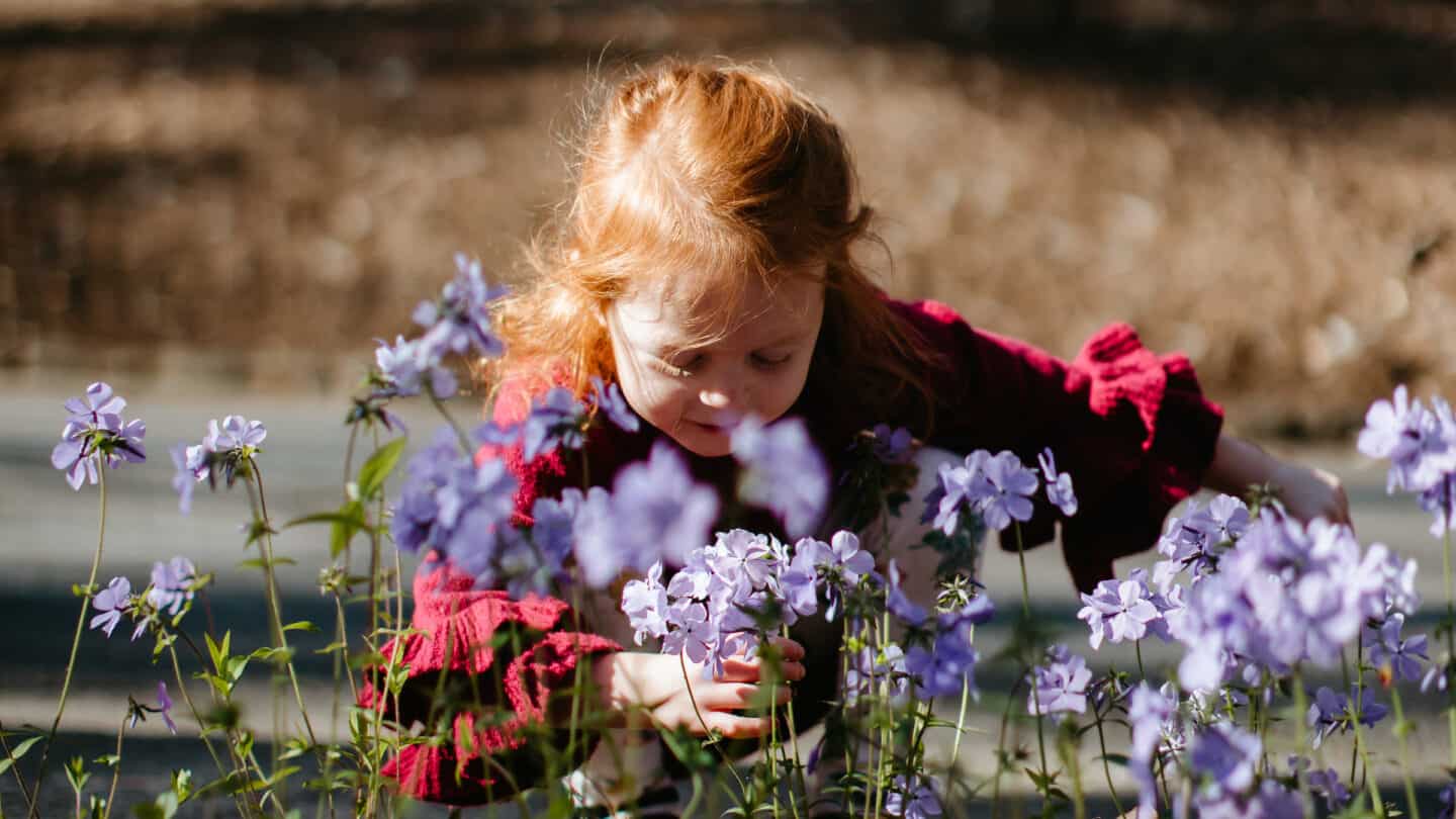Swan Drive, young girl smelling flowers