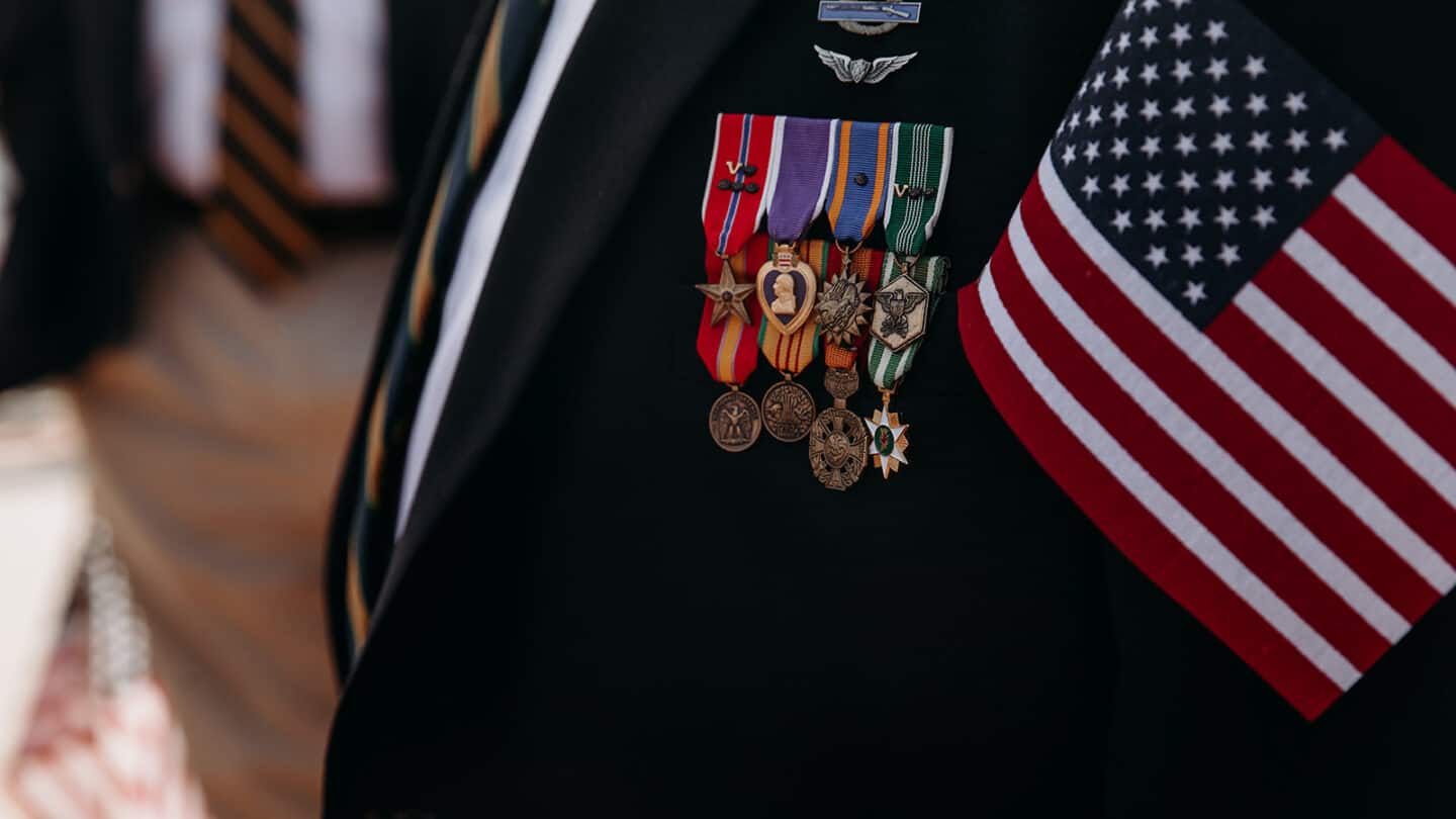 Veteran's Day ceremony, coat with pins and flag