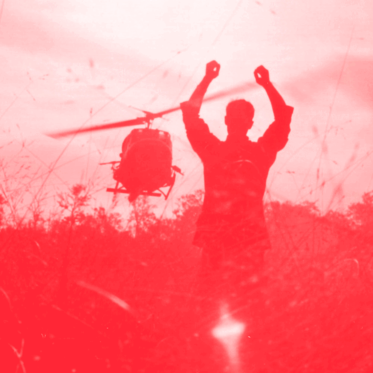 helicopter and man's hands raised in the air