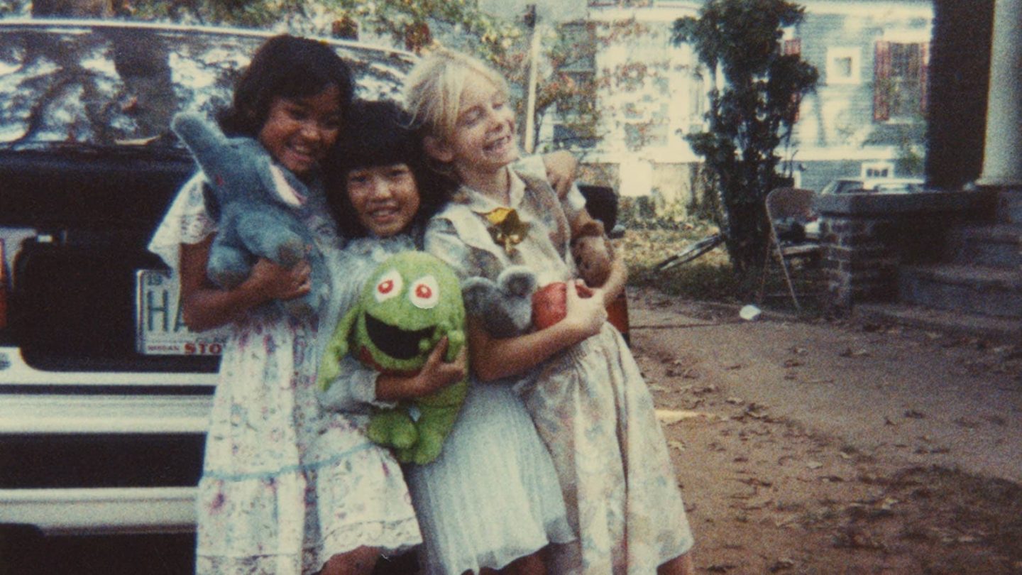 young girls hug holding stuffed animals