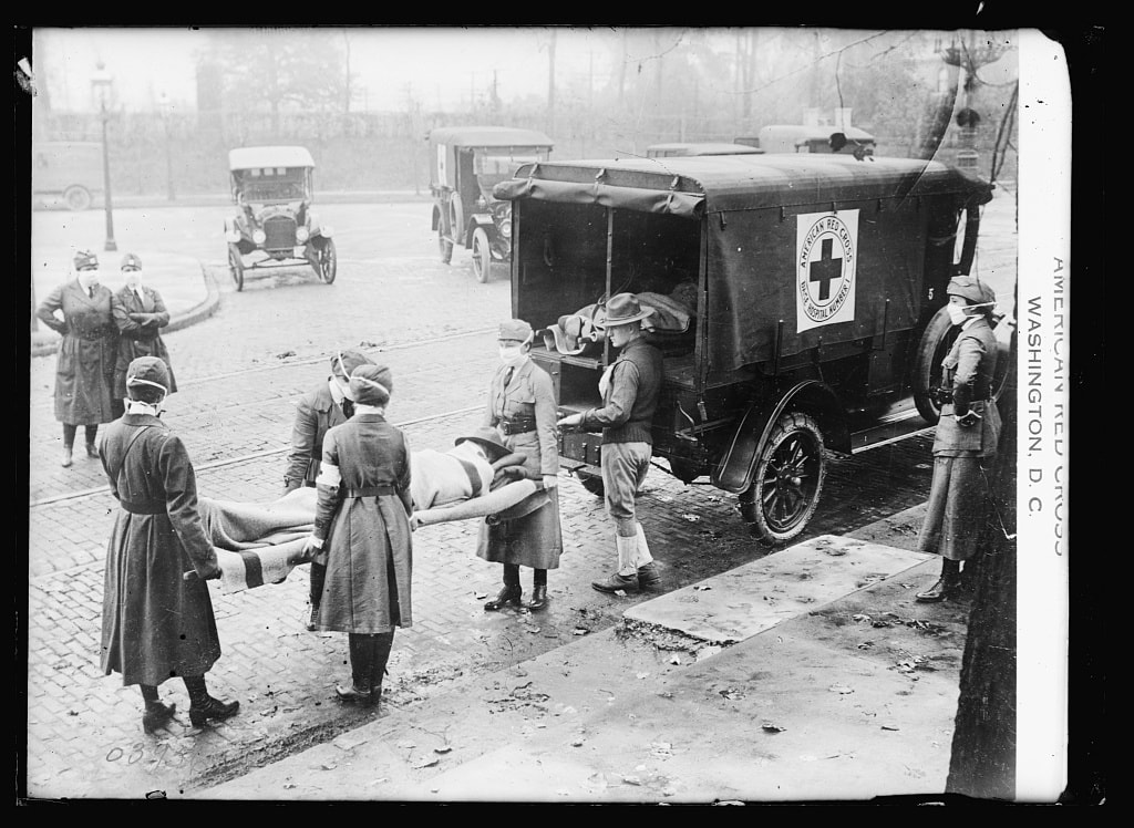 Image of red cross nurses loading patient to red cross vehicle
