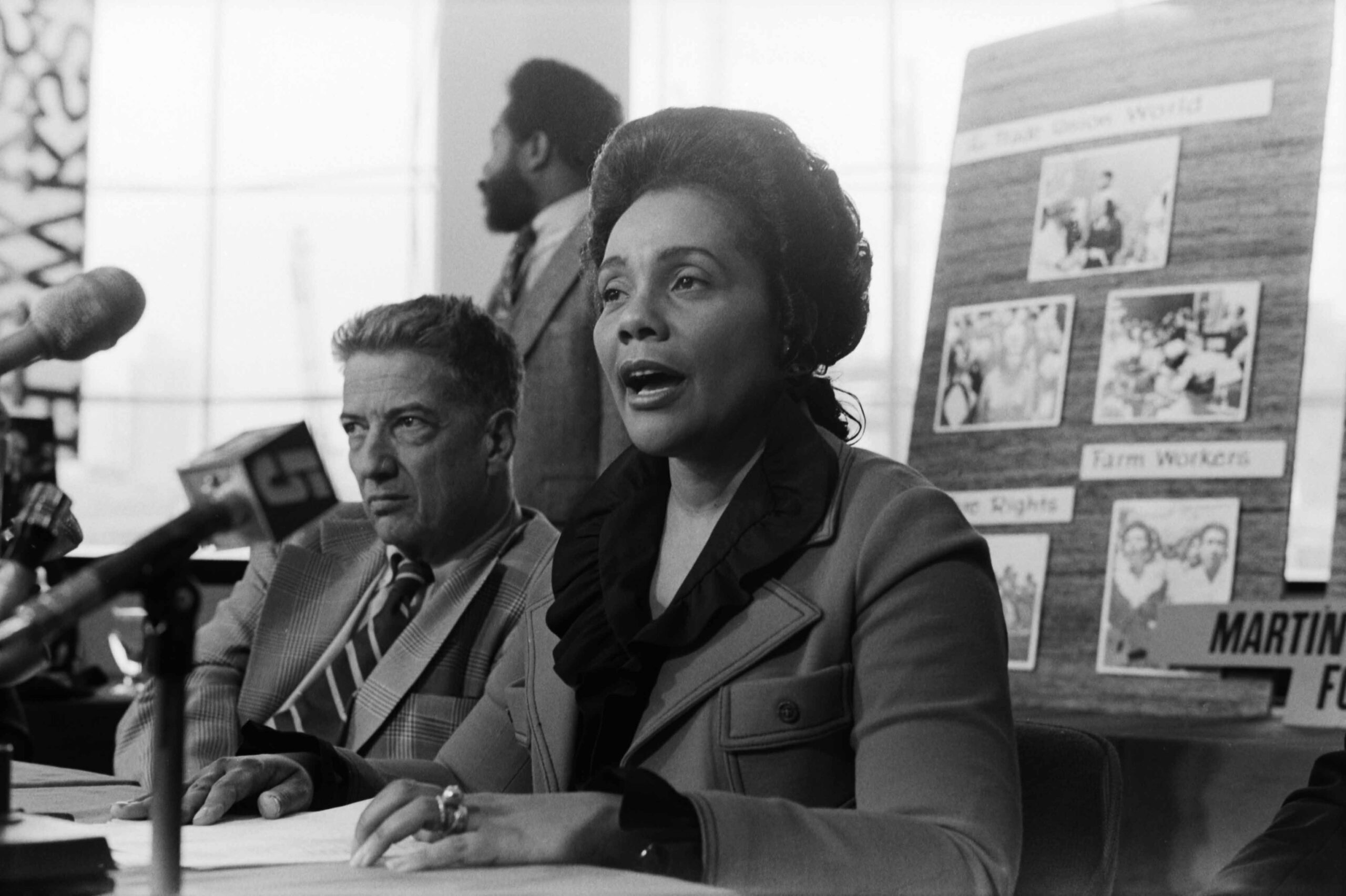 Coretta Scott King speaking in a microphone