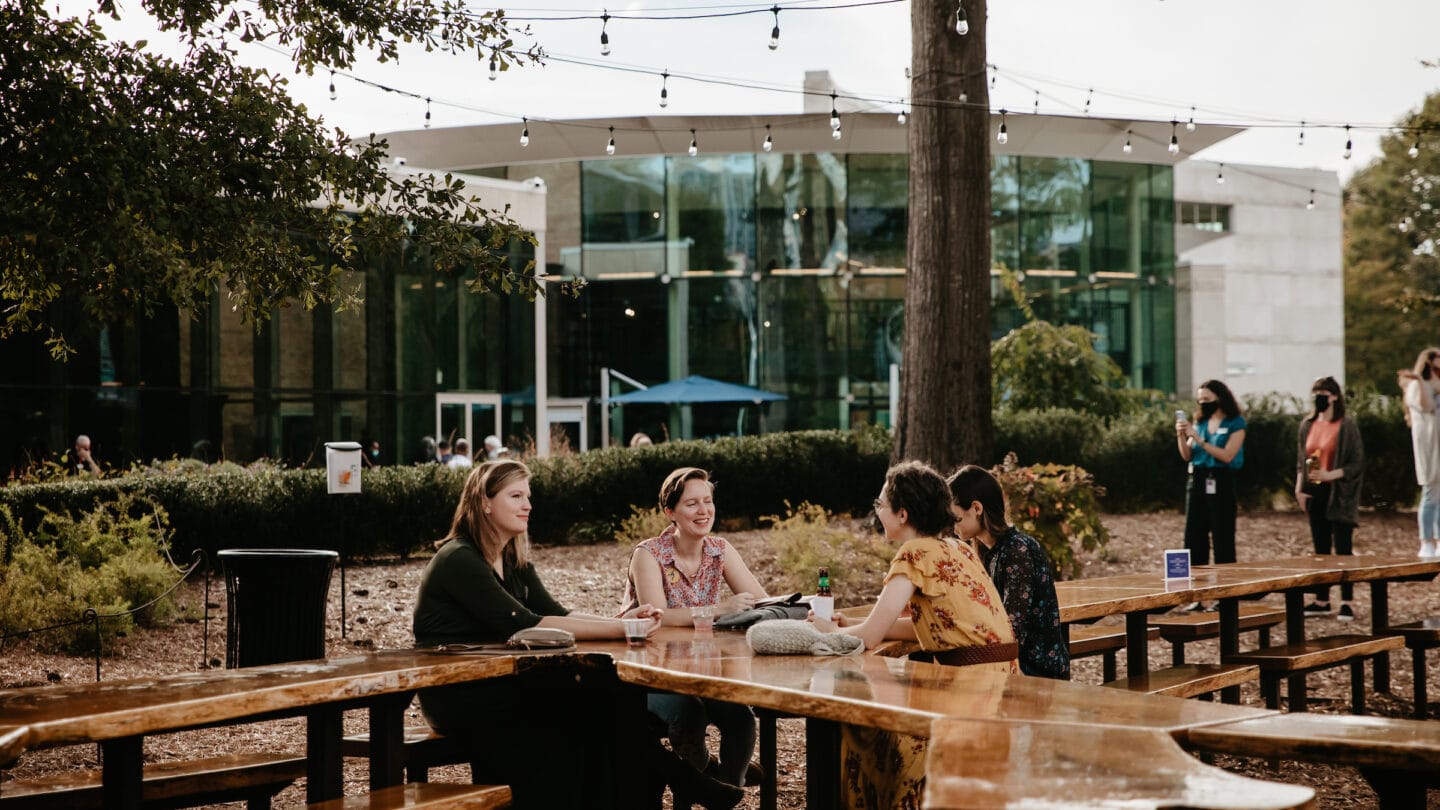 People sitting by the tree table a