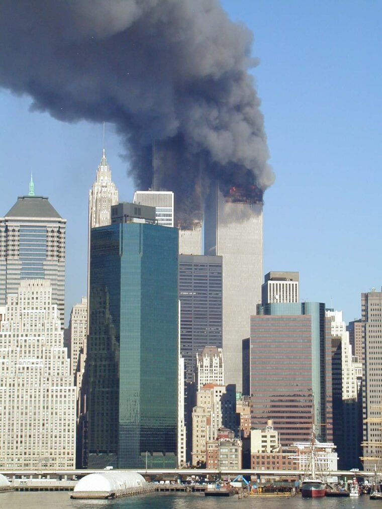 Skyline of Manhattan with smoke billowing from the Twin Towers