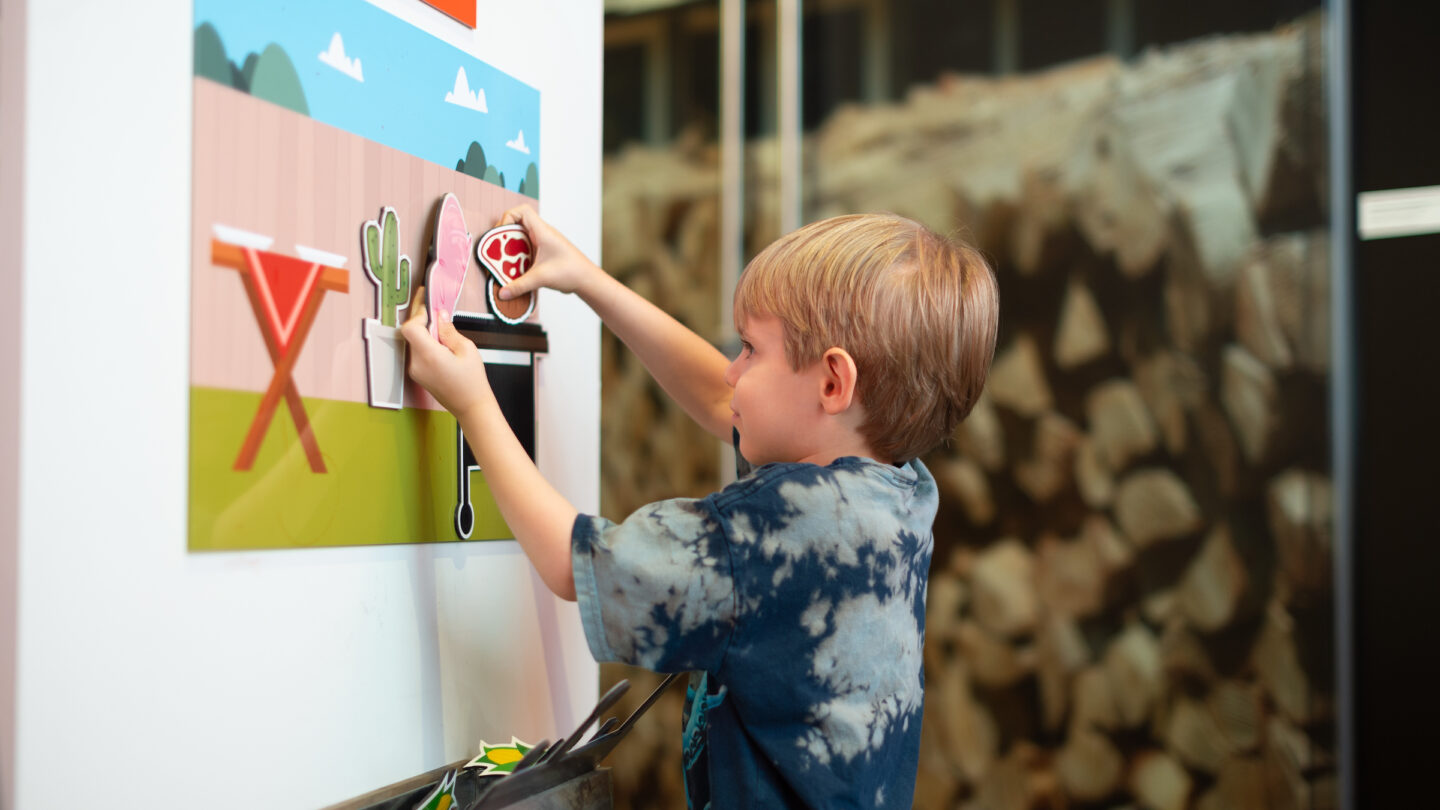 Child playing at Barbecue Nation exhibit opening celebration