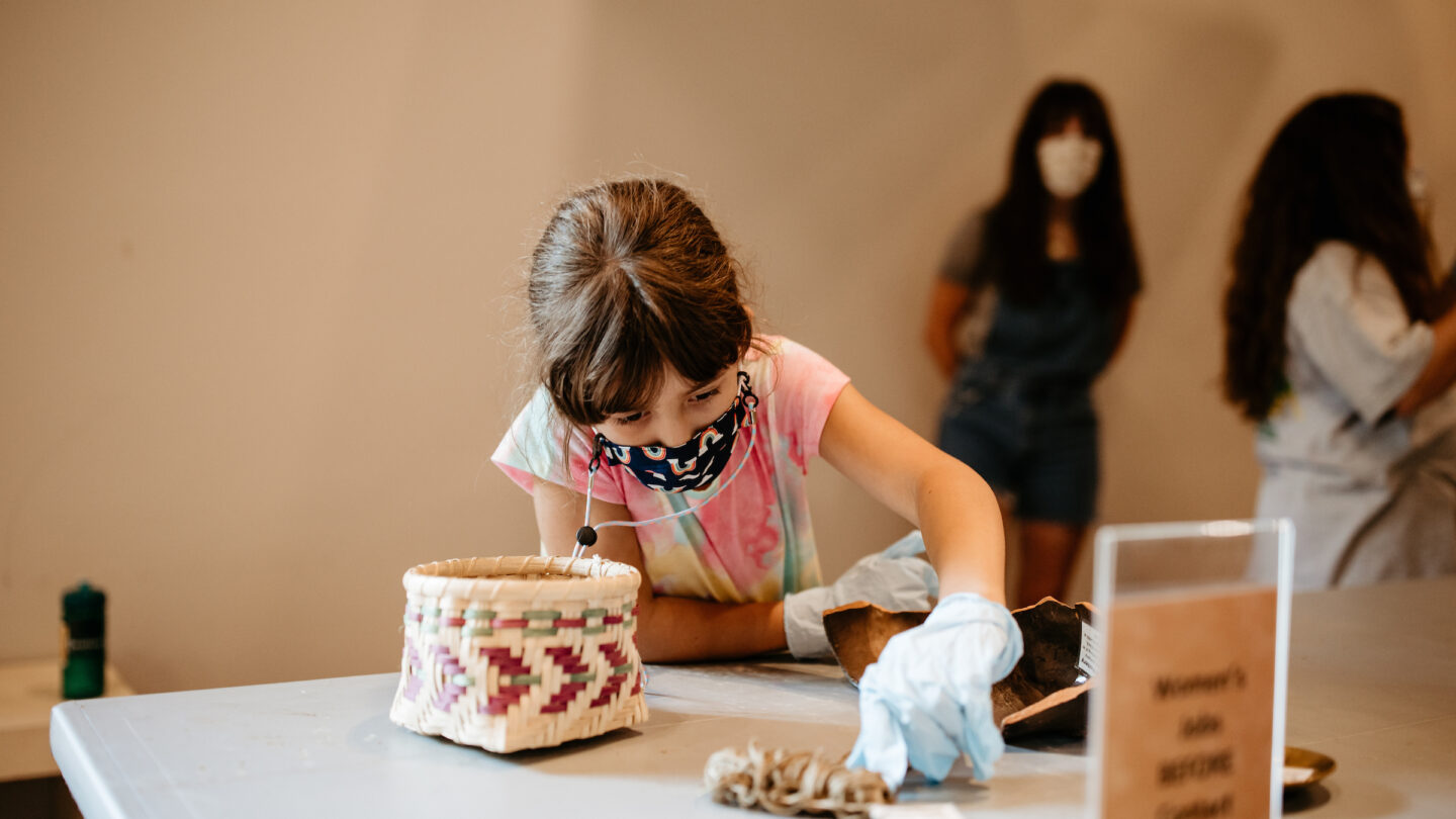 Child hands-on learning at summer camp
