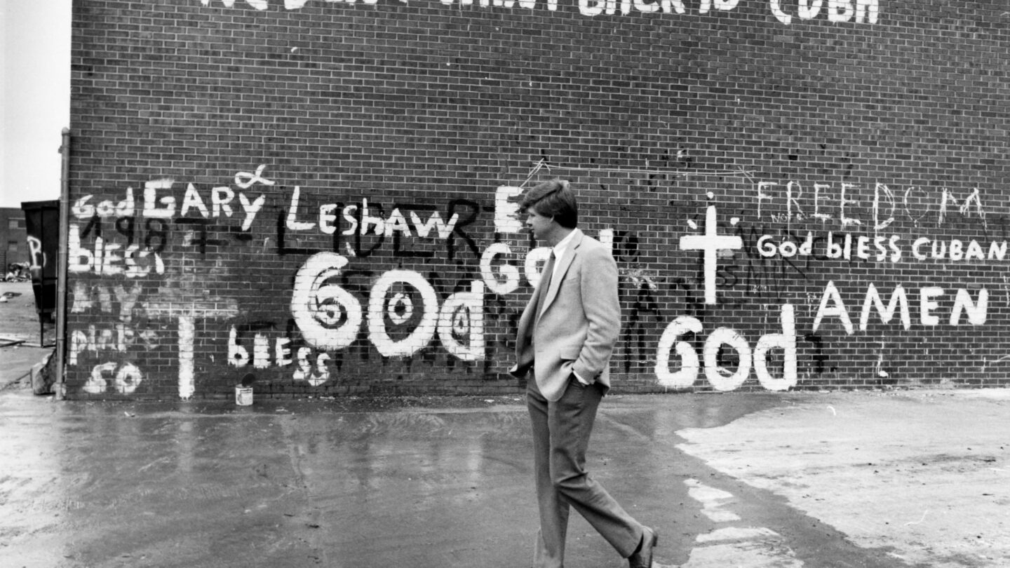 Prison employee Phil Little walks in front of a wall