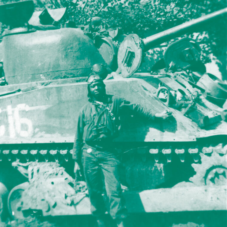Soldier in front of tank