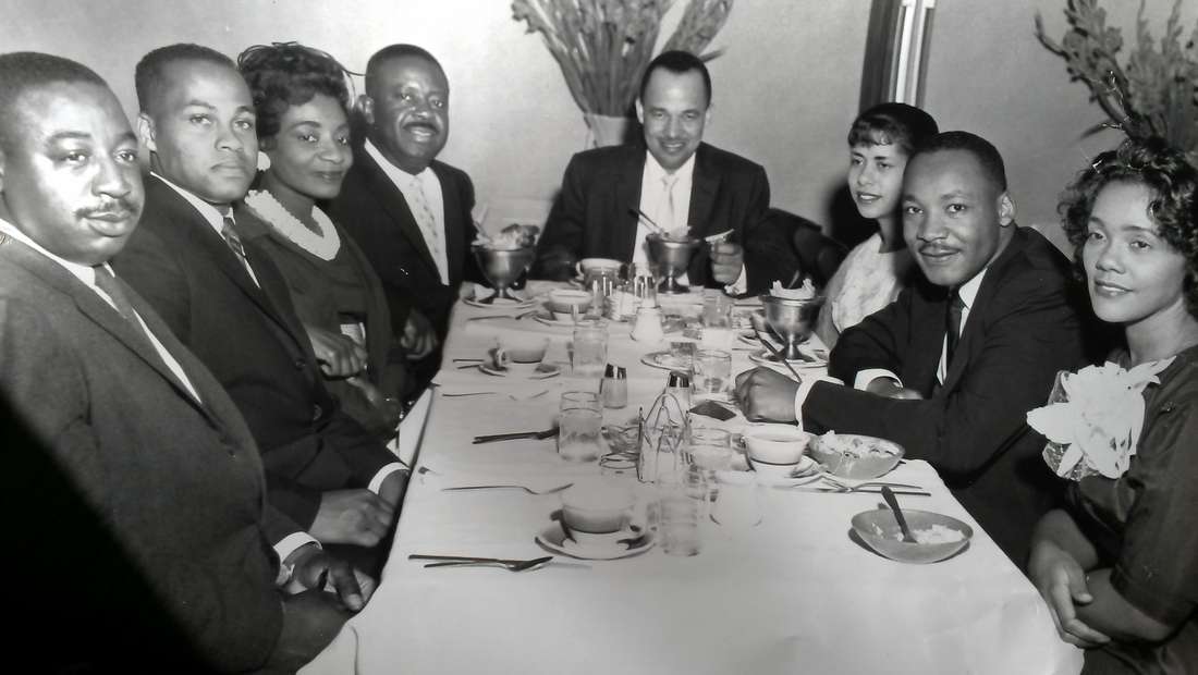 Reverend Fred Bennett, Mr. Isaac Farris, Mrs. Christine King Farris, Reverend Ralph D. Abernathy, Dr. Roy C. Bell, Mrs. Clarice Wyatt Bell, and Mr. and Mrs. King enjoying a meal at Paschal’s Restaurant in 1962