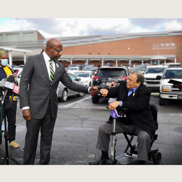 Fist bump between Andrew Young and Reverend Dr.Raphael Warnock