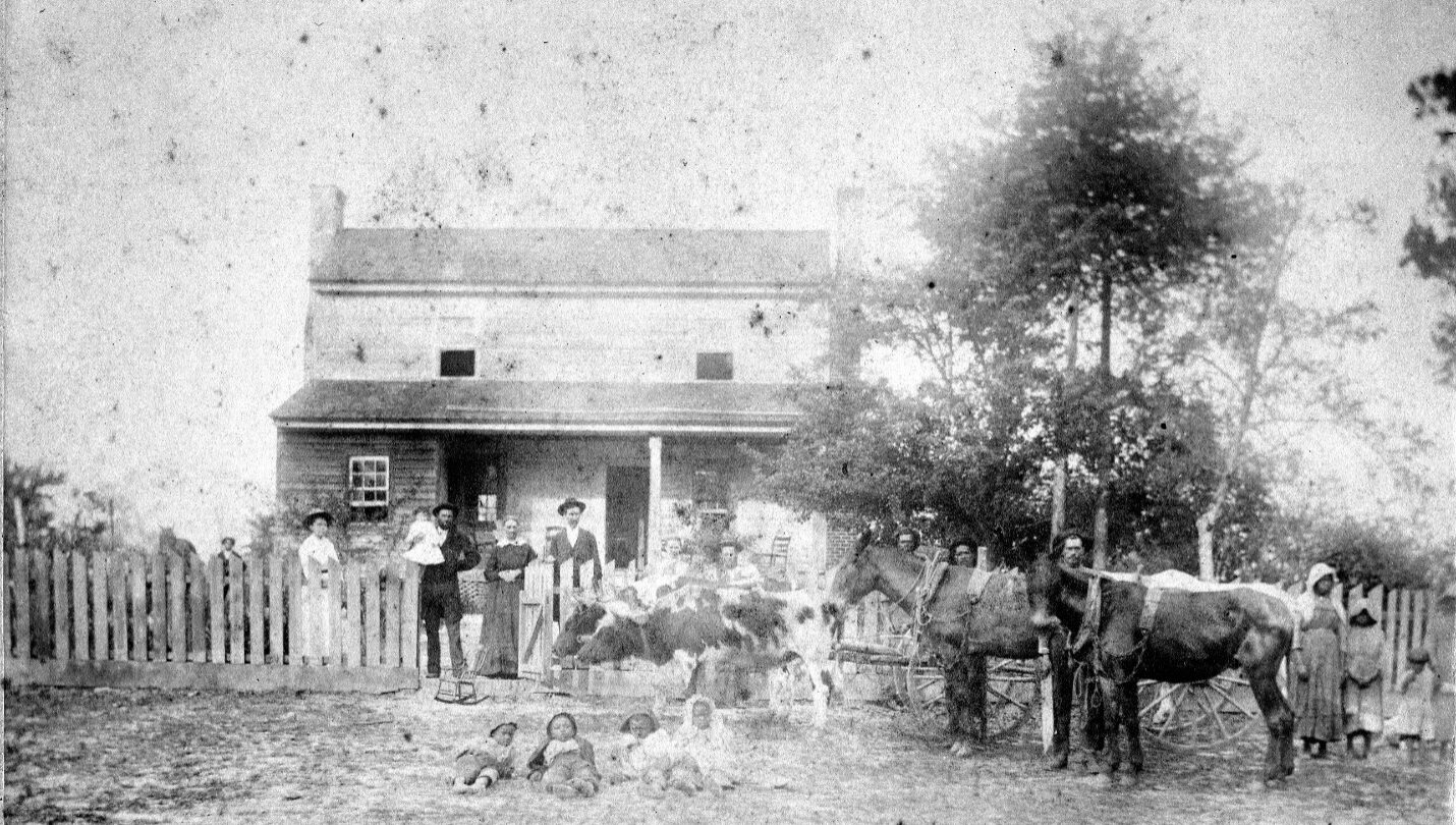 : View of Smith Family, including William Berry and Mary Ella Smith and their children, along with unidentified African American farm workers
