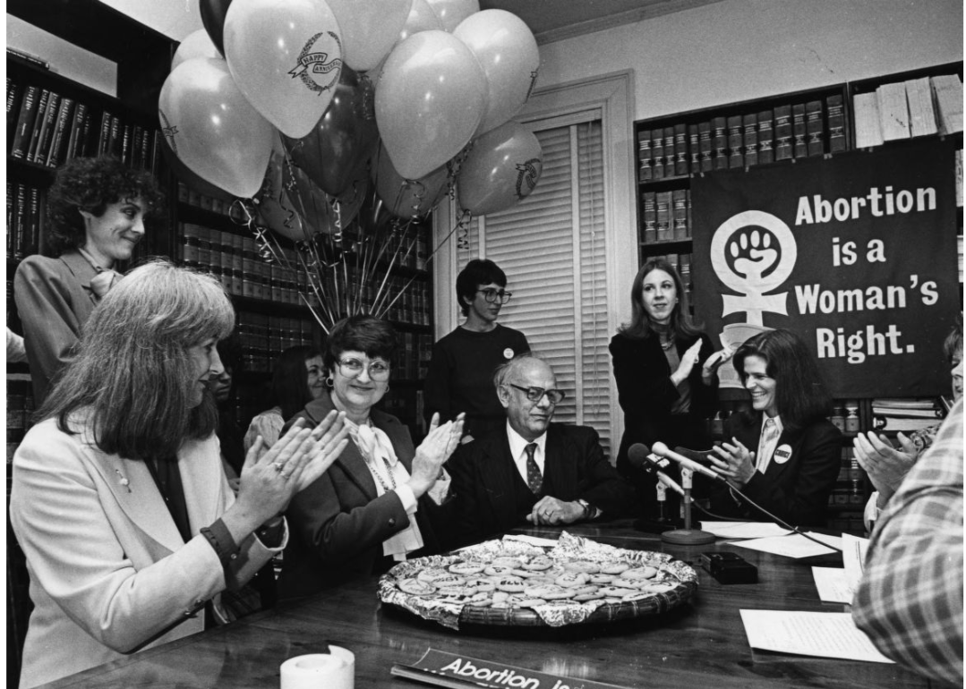 Margie Pitts Hames, center, and other abortion rights advocates celebrate the 9th anniversary of the outlawing of abortion statutes.