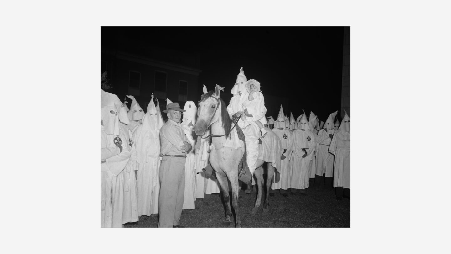 White supremacist man and child on a horse