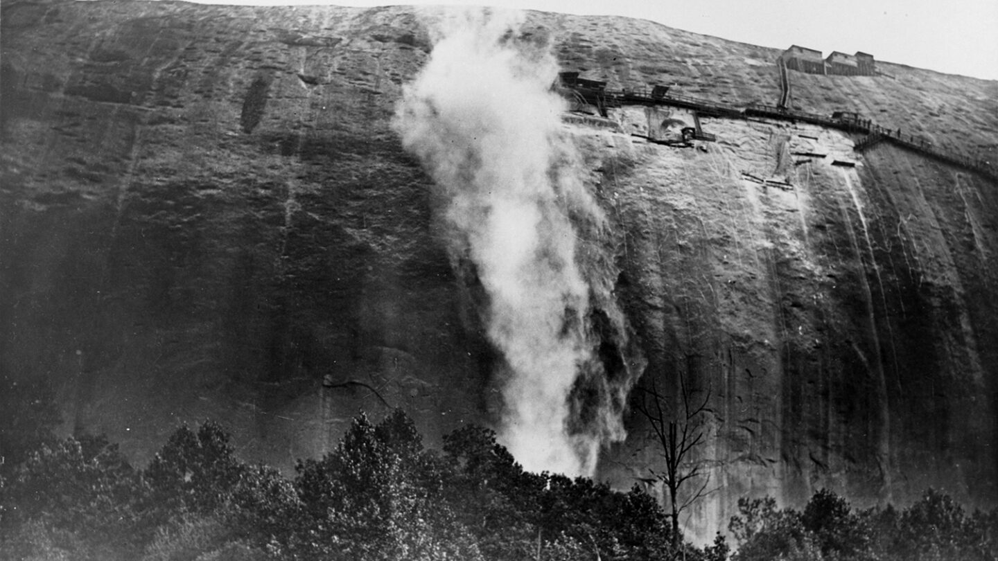 Dust rises from the first iteration of the Stone Mountain carving, circa 1920.