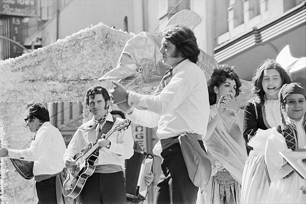 A Hispanic band performs on a float in a Christmas parade