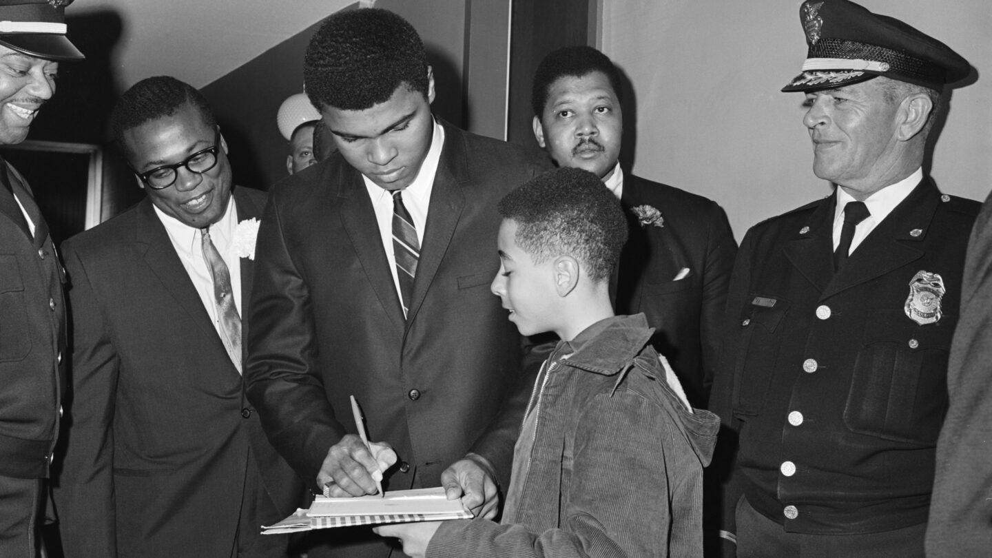 Boxer Muhammad Ali signs an autograph in Atlanta before his boxing match with Jerry Quarry