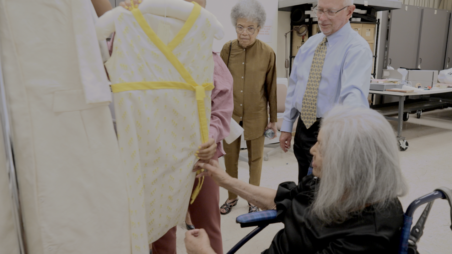 Ann Moore looking at clothing