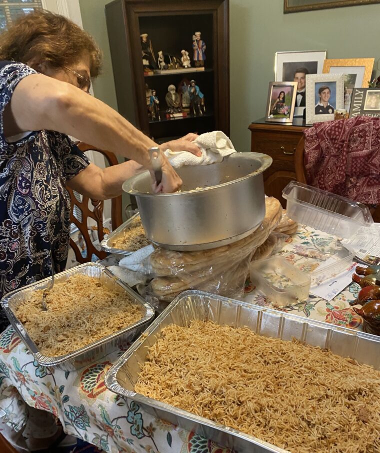 Mariam Nassery serves the Kabuli pulao she's cooked for newly arriving Afghan families