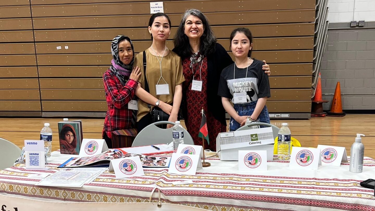 Hogai Nassery, center, with young Afghan women who recently arrived from Afghanistan