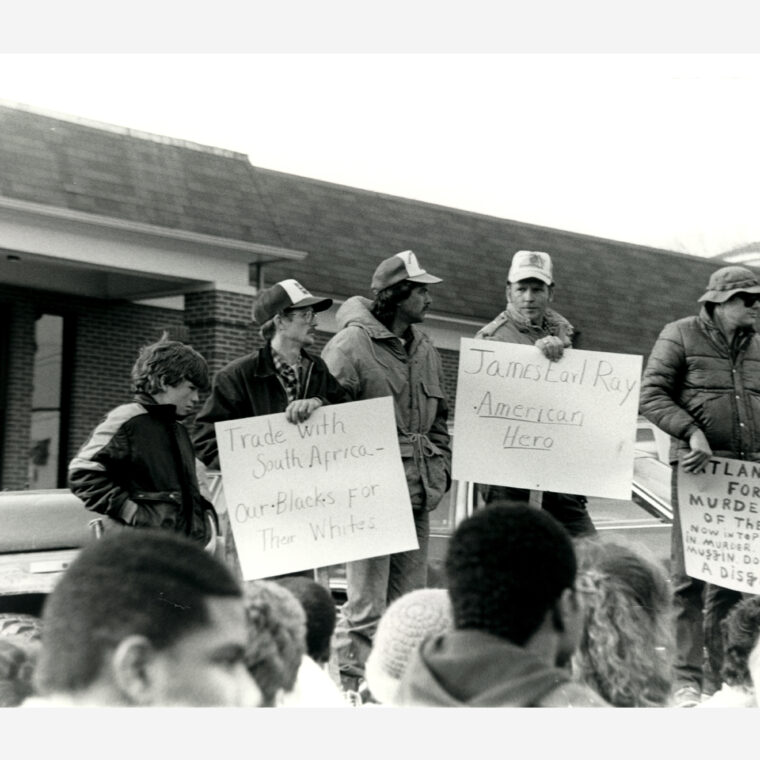 Counter-protestors hold signs at the Brotherhood March