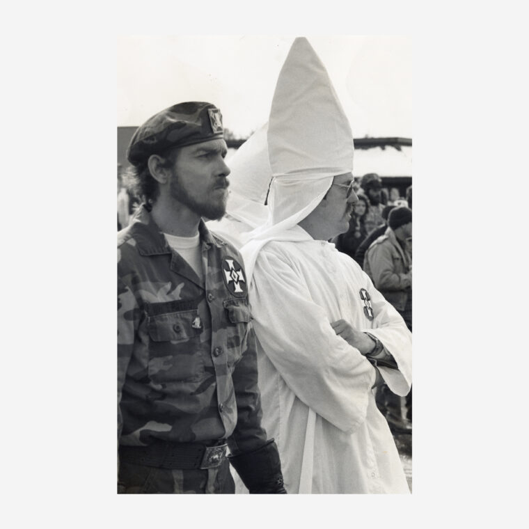 Men in Ku Klux Klan and Confederate regalia watch the second Brotherhood March