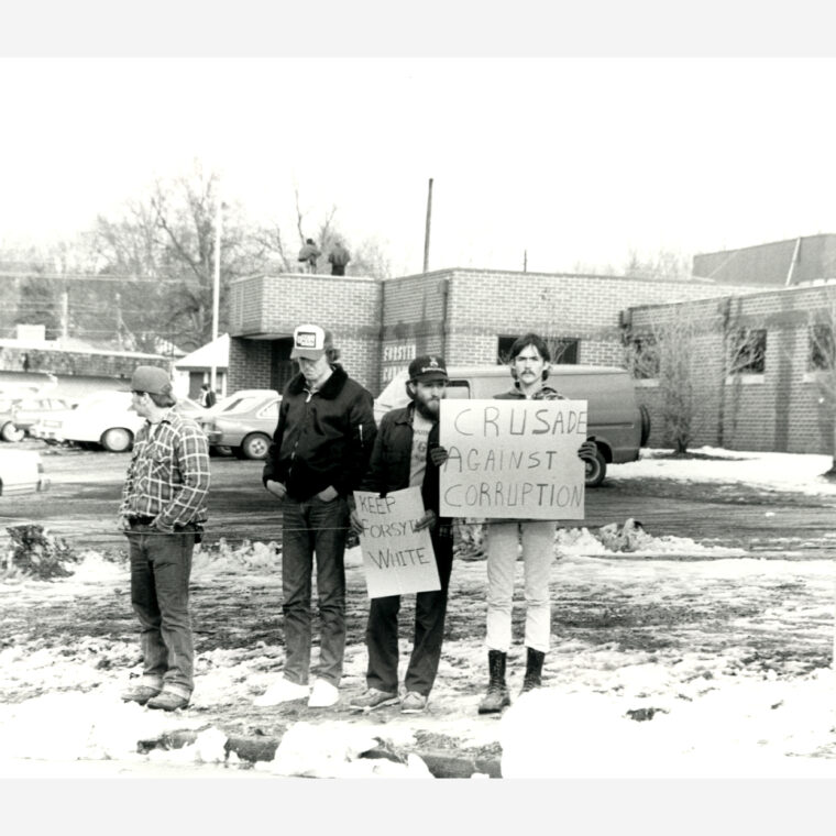 Counter-protestors hold signs at the Brotherhood March