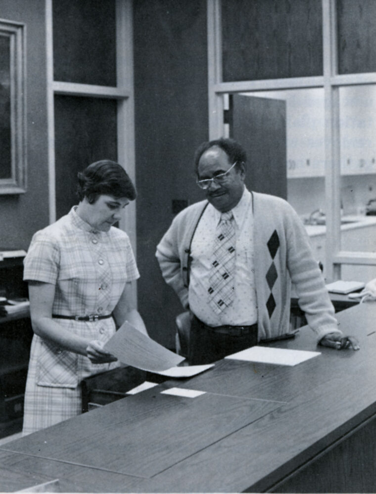 Archives coordinator Patsy Wiggins discusses library procedures with Librarian H. Eugene Craig