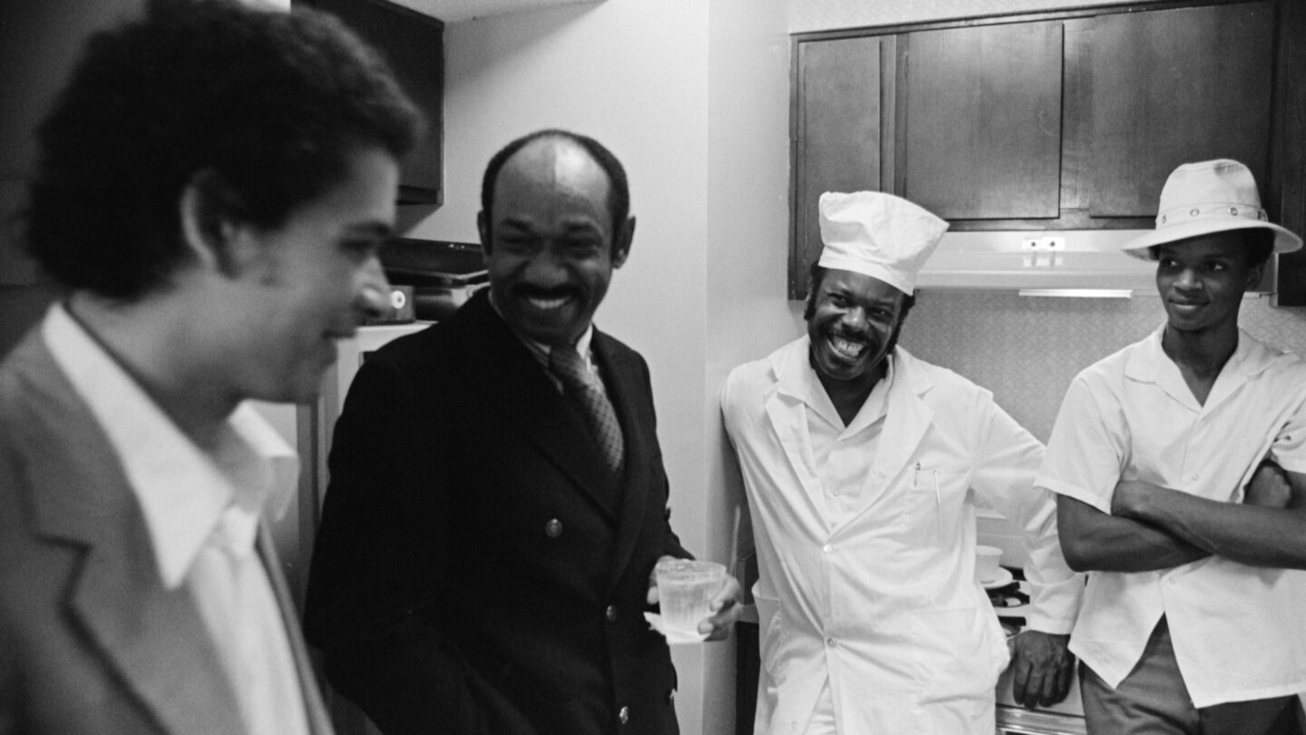 Al Thompson, left, an Atlanta attorney, Herman Russell, second from left, the founder of H. J. Russell Construction Company, and unidentified cooks share a moment