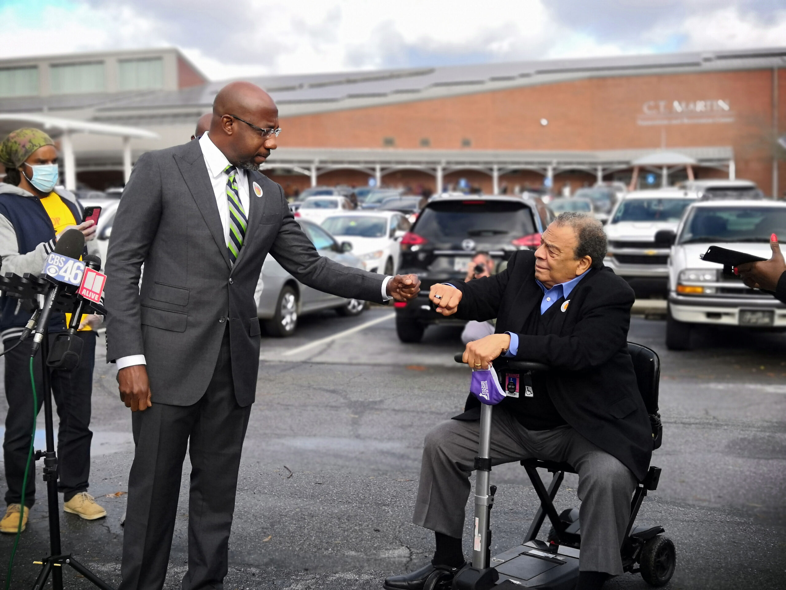Rev. Dr. Raphael Warnock and former Atlanta Mayor and U.S. Ambassador to the United Nations, Andrew Young share a fist bump at C.T. Martin Natatorium and Recreation Center