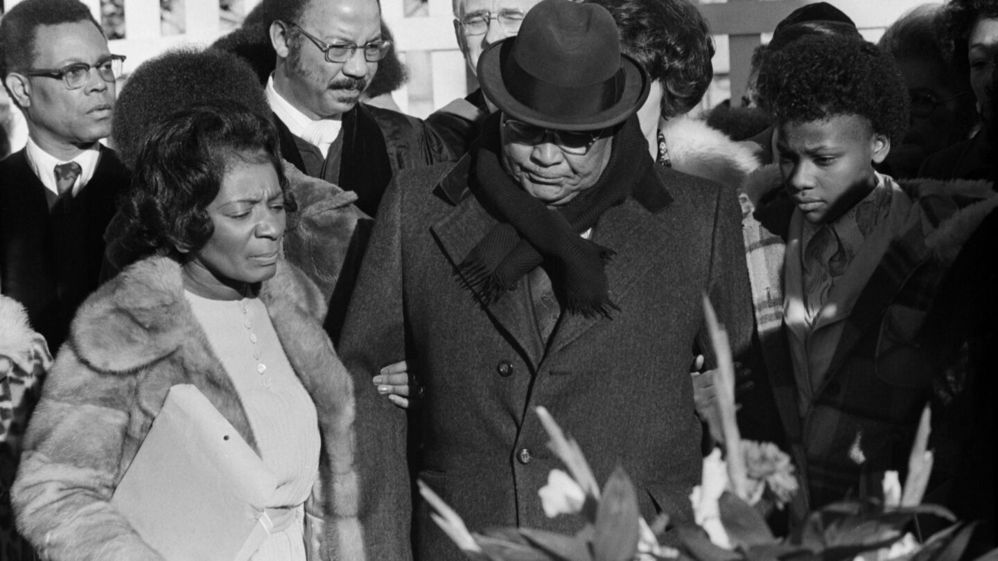 Reverend Martin Luther King, Sr., center, his daughter Christine King Farris, left, and others at the tomb of Dr. Martin Luther King, Jr. during the observance of the slain civil rights leader's 47th birthday