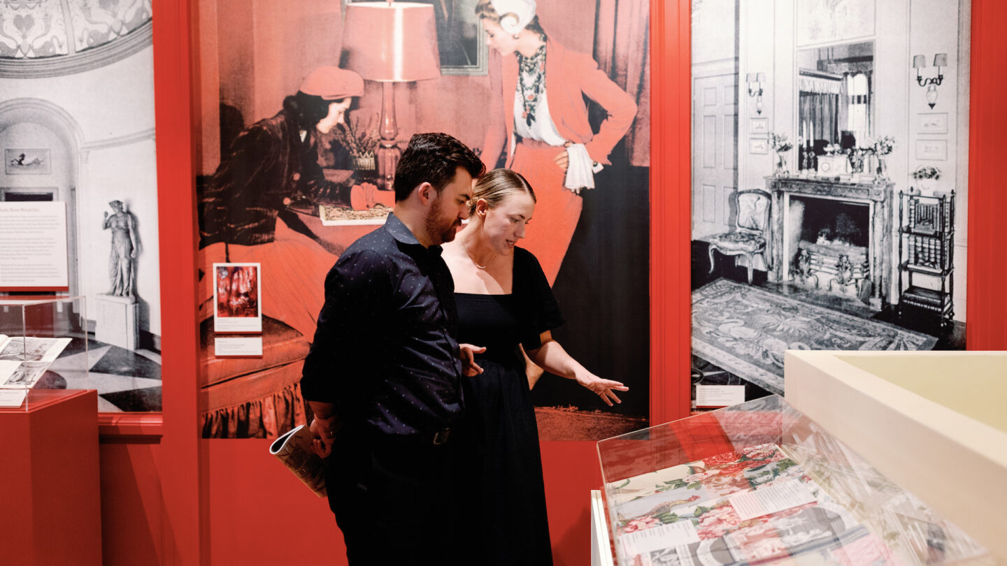 Two people exploring the Ruby Ross Wood Exhibition