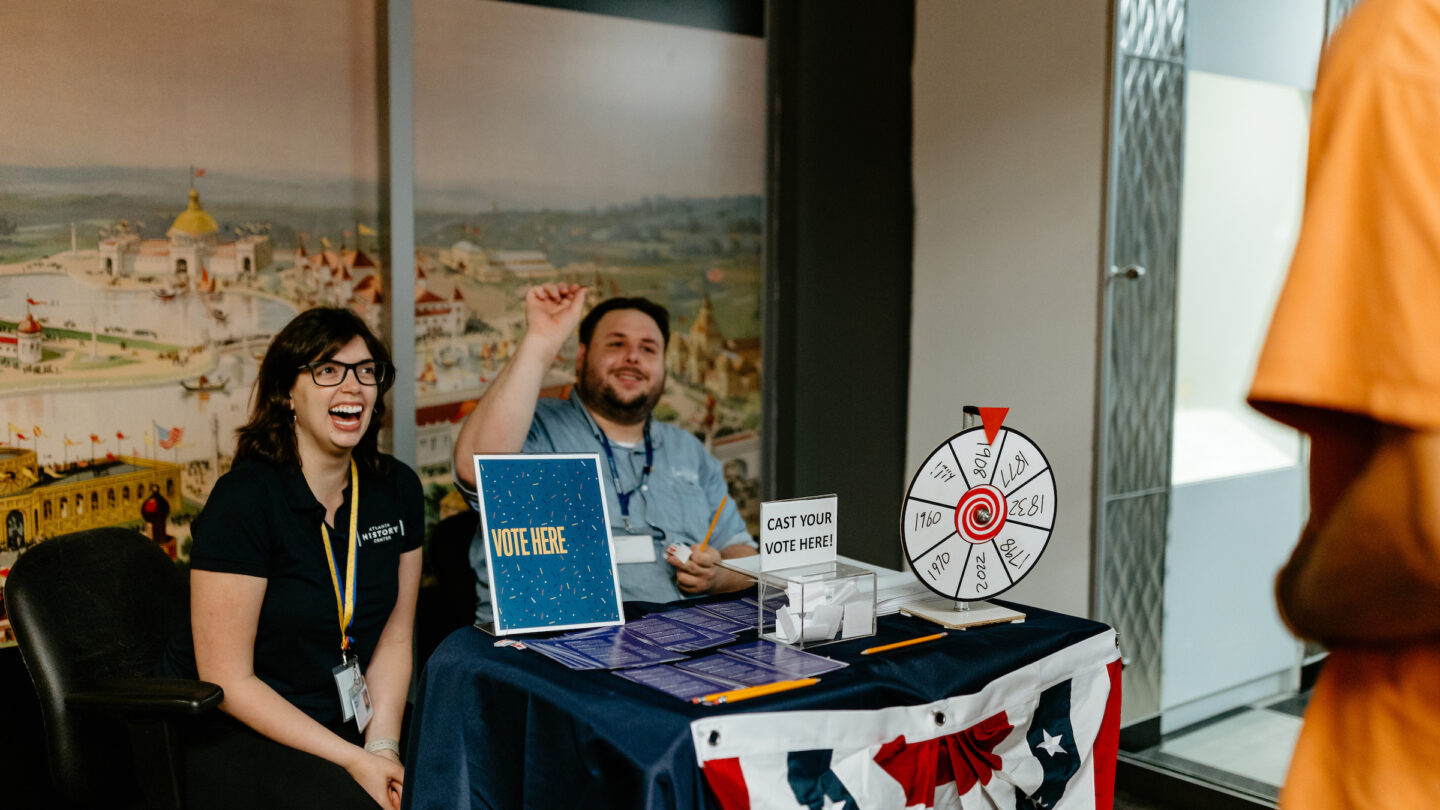 two people sitting behind table booth