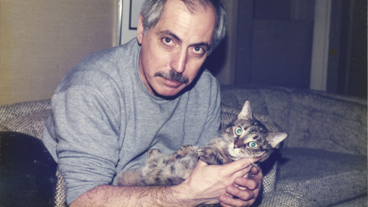 man with beard holding a cat