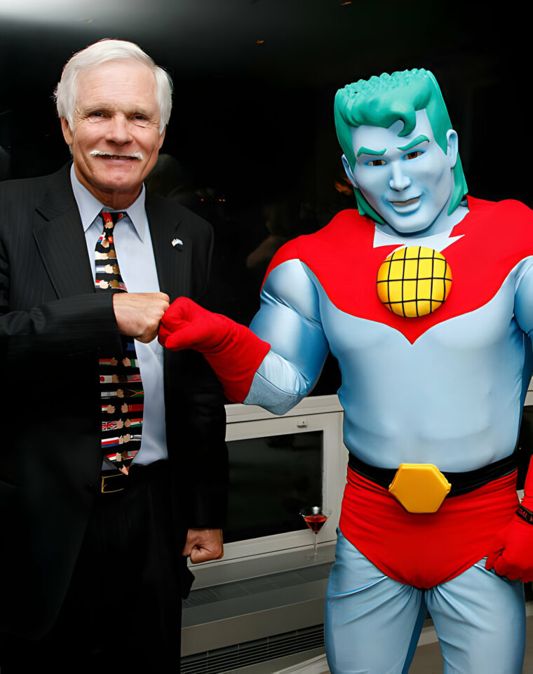 Ted Turner poses with Captain Planet